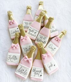 some pink and gold decorated cookies with champagne bottles on them that say we are married