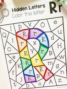 the hidden letters coloring book is open and ready to be filled with color by numbers