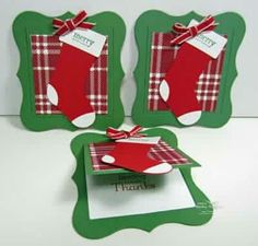 three christmas cards with red and green stocking on them, one has a tag that says merry