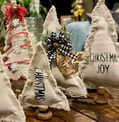 three burlap christmas trees are sitting on a table