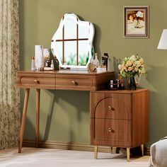 a wooden desk with a mirror and flowers on it