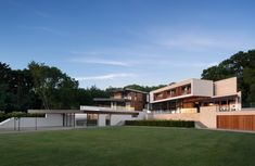 a large modern house in the middle of a grassy area