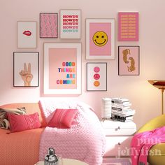 a bedroom with pink walls and pictures on the wall above the bed in front of it