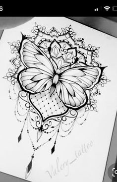 a black and white drawing of a butterfly on top of a piece of paper with writing underneath it