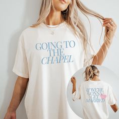 a woman wearing a t - shirt that says going to the chapel and has her hair pulled back