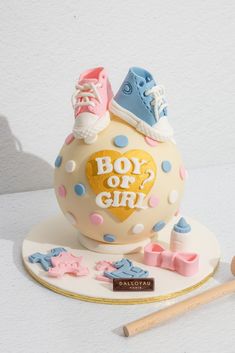 a cake that is shaped like a ball with shoes on top