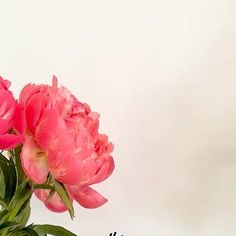 some pink flowers are in a vase on a white tablecloth with the words happy mother's day written below it