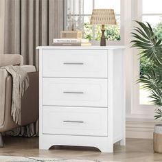 a white chest of drawers in a living room