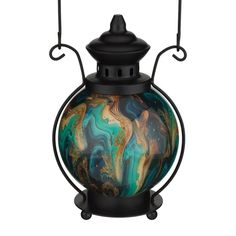 a glass lantern with an artistic design on it