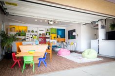 an open living and dining room area with colorful furniture