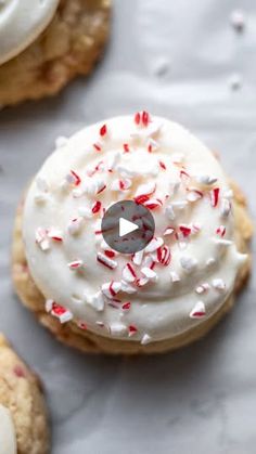 two cookies with white frosting and sprinkles