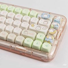 a clear plastic case holds a keyboard with cartoon keys