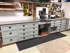 a large workbench with many drawers and tools