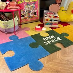 a child's playroom with toys and rugs on the floor in front of it