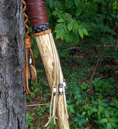 a pair of skis hanging from the side of a tree