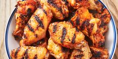 grilled chicken wings in a bowl on a wooden table