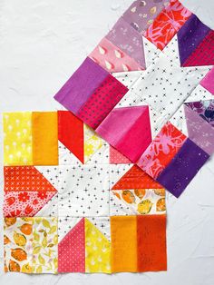 the quilts are all different colors and patterns on the table top, including one star