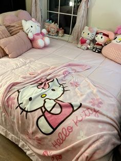 a hello kitty bed with pink sheets and pillows