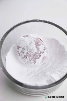 a bowl filled with powdered sugar on top of a table