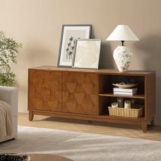 a living room with a couch, table and two pictures on the wall next to it