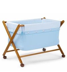 a blue baby crib with wooden legs