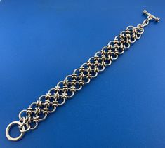 * Sterling Silver Chain Mail Double Row Textured Ring Statement Toggle Bracelet * Length: 8-3/4" * Width: 7/8" * Weight: 80.2 g * Unmarked * Professionally assayed * Condition: Great, as pictured. * S3222    Exported By ExportYourStore :) Bracelet Ring Chain, Make Chainmail, Chainmail Armor, Monkey Tattoos, Jump Ring Jewelry, Simple Silver Jewelry, Chainmail Jewelry, Chainmaille Bracelet, Chain Maille Jewelry