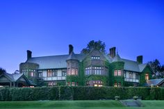 a large house with ivy growing on the side of it