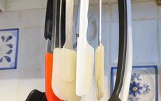 scissors and other kitchen utensils hanging from hooks