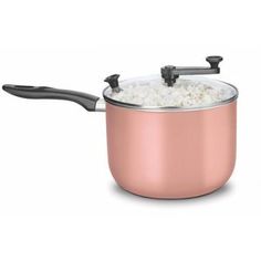 a pink pot filled with rice on top of a white table