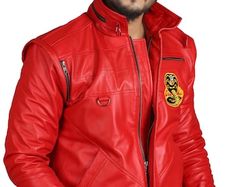 a man wearing a red leather jacket with a badge on the front and back side