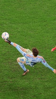 two soccer players in action on the field