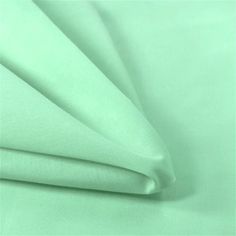 a close up view of a plain light green fabric