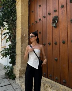 a woman standing in front of a wooden door