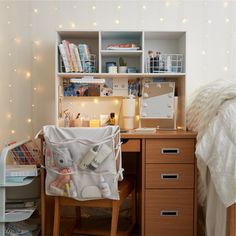 a desk with a chair and some books on it in front of a book shelf