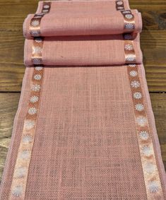 a pink rug on top of a wooden floor