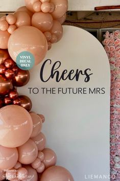 balloons are hanging on the wall in front of a sign that says cheers to the future mrs