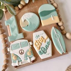 decorated cookies are arranged on a wooden board