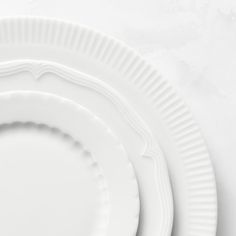 three white plates stacked on top of each other