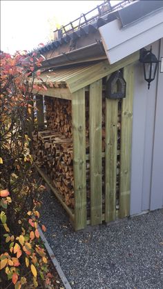 there is a shed that has logs in it and some lights on the outside wall