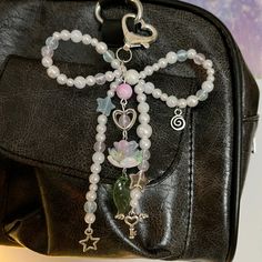 a black purse with some beads and charms on it