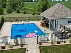 an aerial view of a backyard with a swimming pool