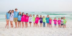 a group of people standing next to each other on a beach