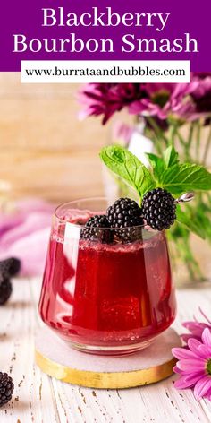 blackberry bourbon smash in a small glass with blackberries on top