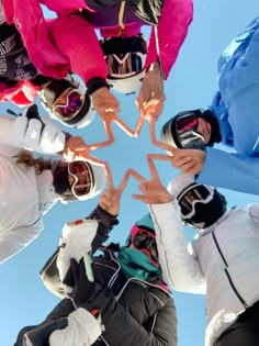 a group of people standing in a circle with their hands together