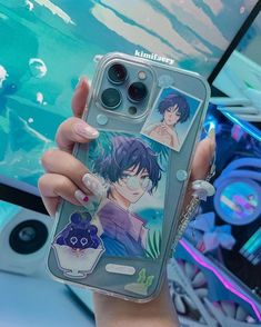 a woman holding up an iphone case with anime characters on it