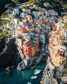 an aerial view of some buildings and boats on the water in cinquefoila, italy