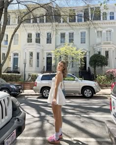 a woman standing in the middle of a street