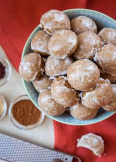 a bowl filled with donuts next to bowls of powdered sugar and other ingredients