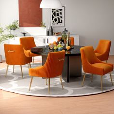 an orange and black dining room table surrounded by yellow chairs with white circles on the rug