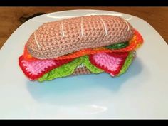 a crocheted sandwich sitting on top of a white plate